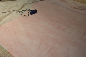 Hair dryer removes wrinkles from wool batting